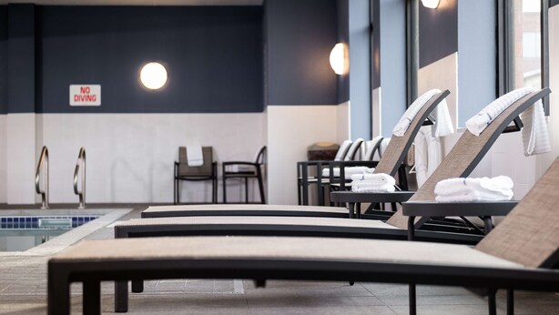 A poolside area with lounge chairs, a 'NO DIVING' sign, and a pool. - Hampton Inn & Suites La Crosse Downtown (La Crosse)