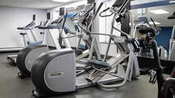 A gym with treadmills, ellipticals, and a stationary bike.