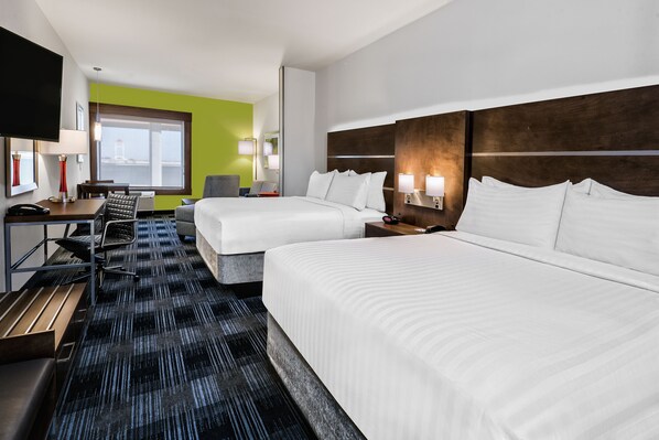 A hotel room with two beds, a desk with a chair, a TV, and a large window with a view. - Holiday Inn Express & Suites Austin - Round Rock Area by IHG (Austin)