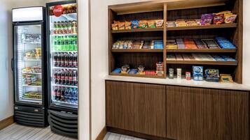 A vending machine and a snack display in a public area.