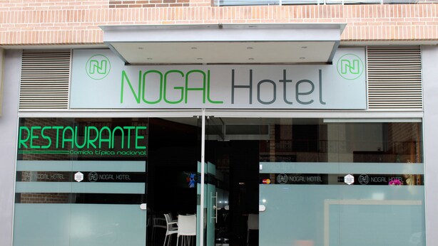 The exterior of NOGAL Hotel with a sign indicating it is a restaurant. - Nogal Hotel (La Ceja)
