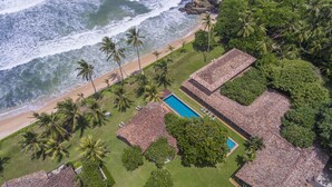 An aerial view of a resort with a beach, palm trees, and a swimming pool. - The Frangipani Tree By Edwards Collection (Unawatuna)