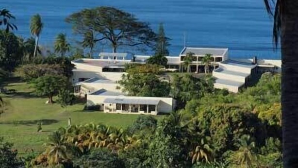 A coastal property with multiple buildings, lush greenery, and a view of the ocean. - Richmond Vale Diving and Hiking Center - Hostel (Chateaubelair)