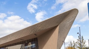 A modern building with a unique angular roof design and large windows. - Hotel Bienvenue (Rotterdam)