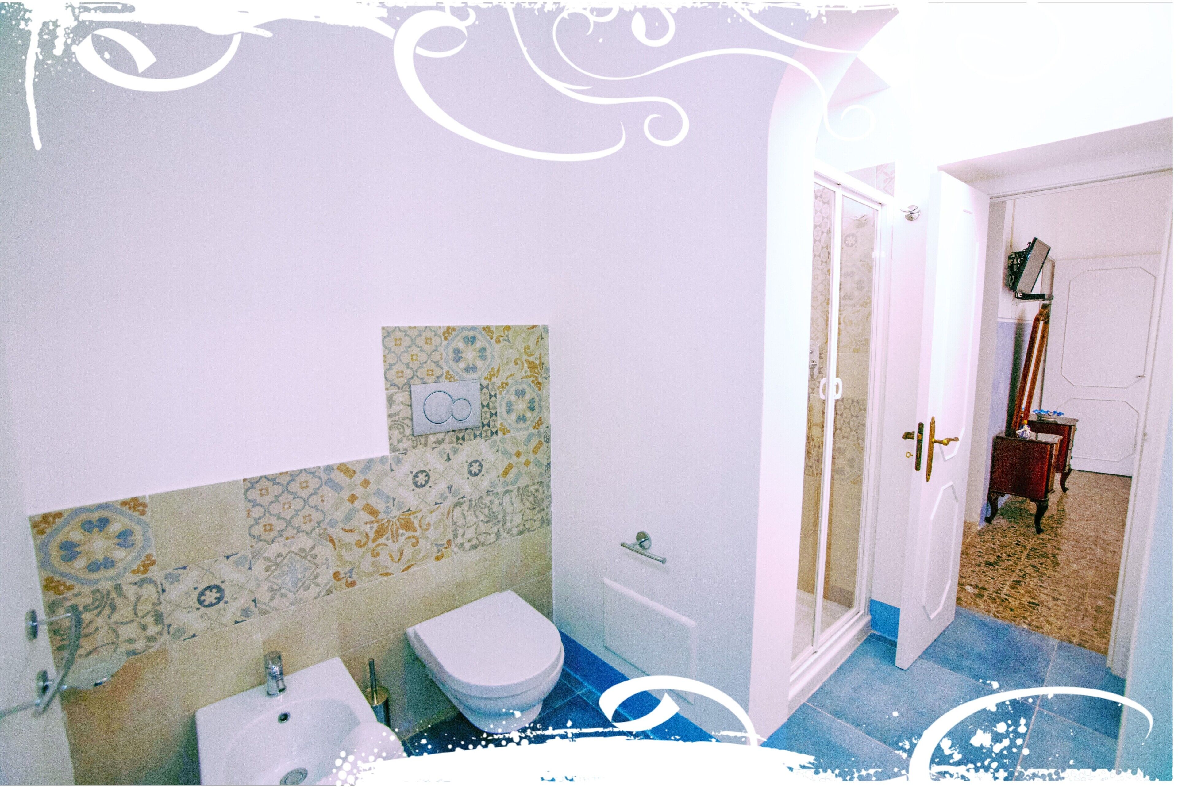 A bathroom with a white toilet, a sink, and a shower area.
