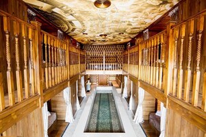 A long, narrow hallway with wooden railings and a central water feature.