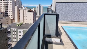 A rooftop pool with a clear view of the sea and surrounding buildings. - Guarapari Praia (Guarapari)