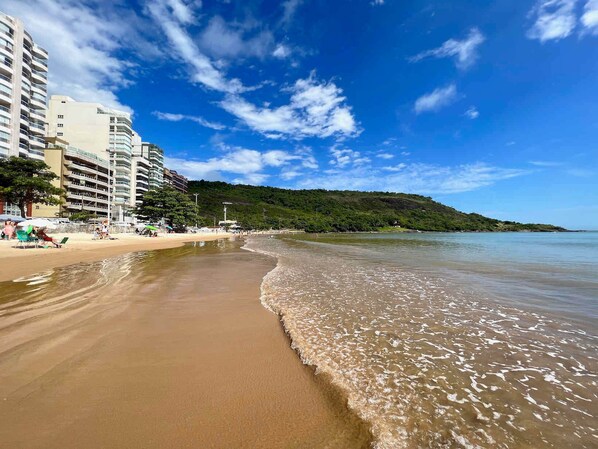 On the beach, white sand, beach cabanas, sun-loungers