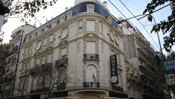 A historic building with a prominent hotel sign, multiple balconies, and classic architectural details. - Ayacucho Palace Hotel (Buenos Aires)