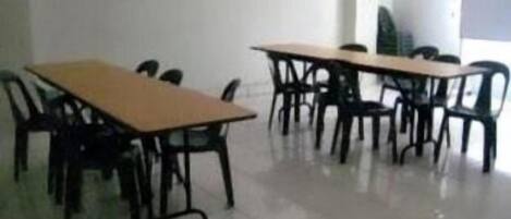 A conference room with two tables and chairs.
