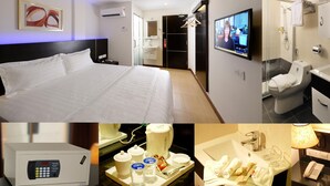 Une chambre d’hôtel comprenant un lit, une télévision, une salle de bain avec douche et un mini-bar.