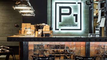 A bar area with a sign reading "PROSECCO BAR" and a tiled backsplash.