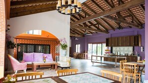 A spacious living area with a high ceiling, wooden beams, and a large dining table. - Hotel Toscana Trad (Trat)
