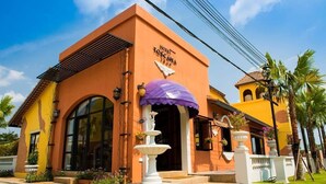 A hotel with a Mediterranean architectural style, featuring a large arched entrance and a fountain in front. - Hotel Toscana Trad (Trat)