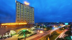 A modern hotel with a prominent sign, multiple floors, and a well-lit entrance area. - Muong Thanh Grand Quang Nam (Da Nang)