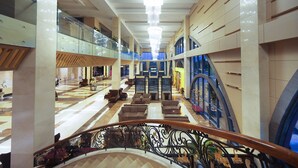 A spacious lobby with a grand chandelier, multiple seating areas, and a modern architectural design. - Muong Thanh Grand Quang Nam (Da Nang)
