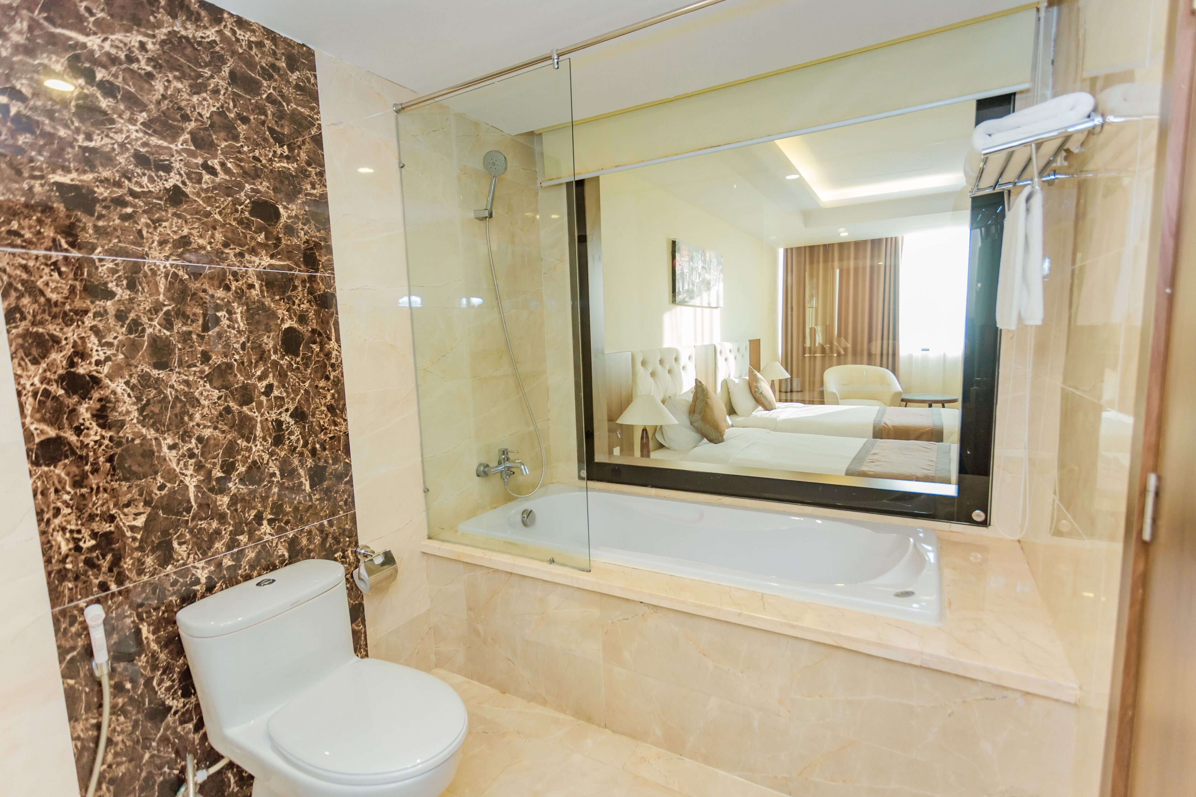 premium deluxe twin room | bathroom | combined shower/bathtub, designer toiletries, hair dryer, slippers