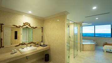 A modern bathroom with a large mirror, a sink, and a glass-enclosed shower.