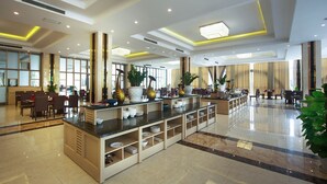 A spacious lobby with a central counter, seating areas, and large windows allowing natural light. - Muong Thanh Grand Quang Nam (Da Nang)