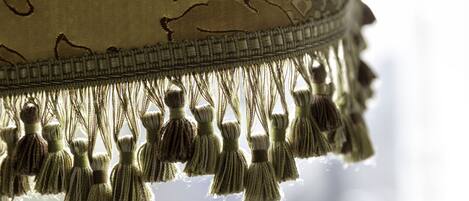 A close-up of a fabric with tassels and a decorative border.