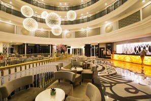 Relax in a spacious lobby with plush sofas and a balcony offering a view of the lobby below.