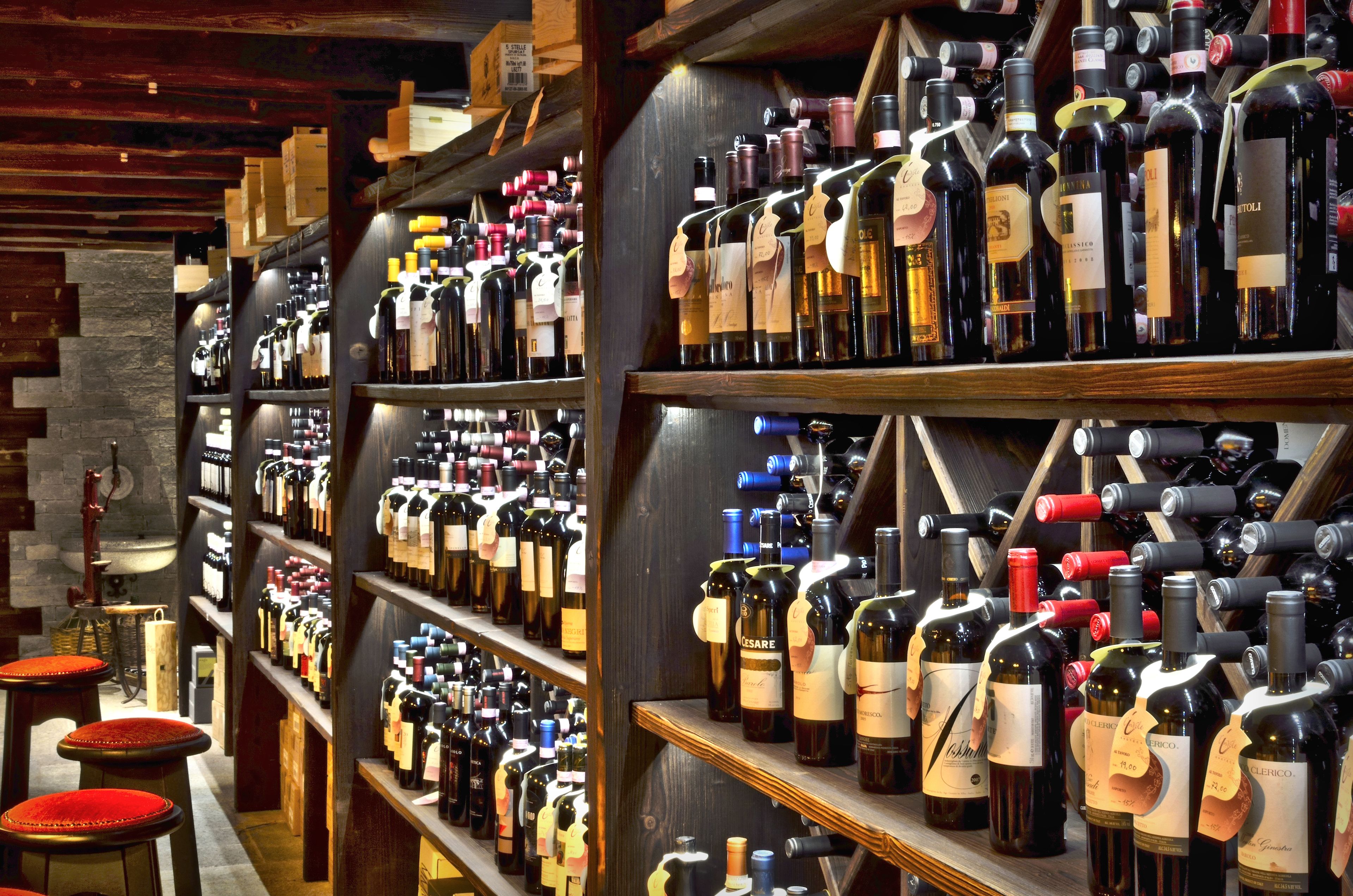 A wine cellar with shelves of wine bottles.