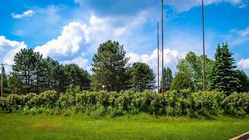 A lush green landscape with a sign for the Moberly Motel.