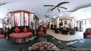 A spacious lobby with a curved seating area, a ceiling fan, and a reception desk. - Vientiane SP Hotel (Vientiane)