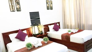 A hotel room with two beds, each with a wooden headboard, white bedding, and a brown throw blanket. There are two bedside tables with lamps and decorative items. - Vientiane SP Hotel (Vientiane)