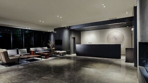 A modern lobby with a reception desk, seating area, and large windows. - Ramada by Wyndham Gunsan (Gunsan)