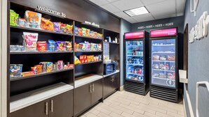 A snack vending area with various snack options and a refrigerated section with beverages. - Hampton Inn & Suites New Albany Columbus (New Albany)