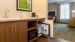 A compact kitchen with a microwave, coffee maker, and refrigerator. - Hampton Inn & Suites New Albany Columbus (New Albany)