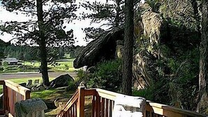 A wooden staircase leading up to a building with a stone wall. - Thunderheart (Custer)