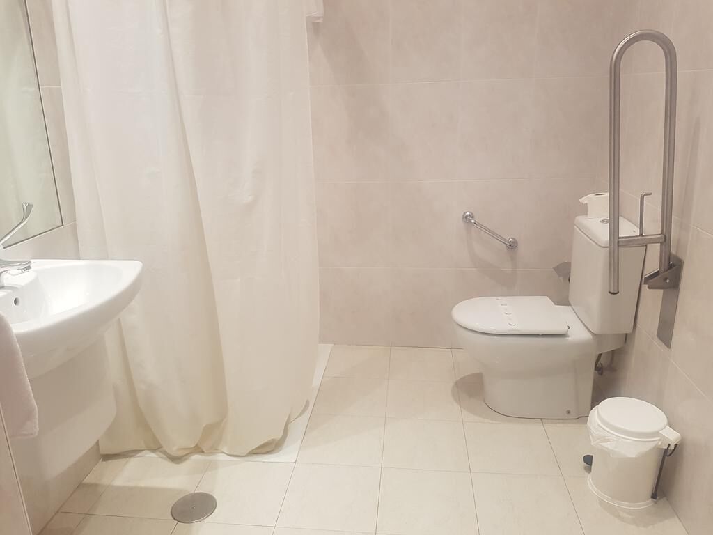 Un baño con inodoro, bidé y lavamanos.