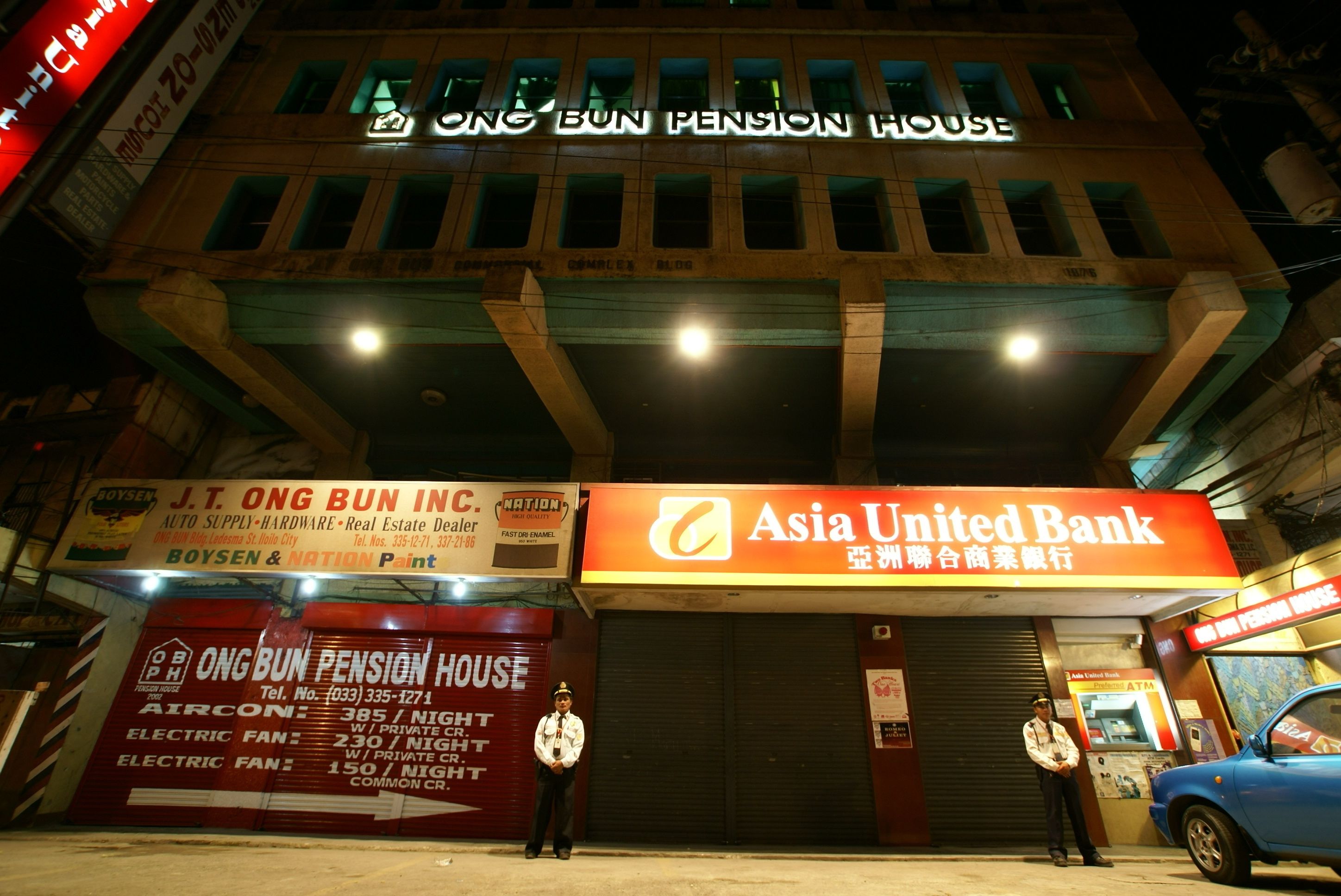 A building with signage for Ong Bun Pension House and Asia United Bank.