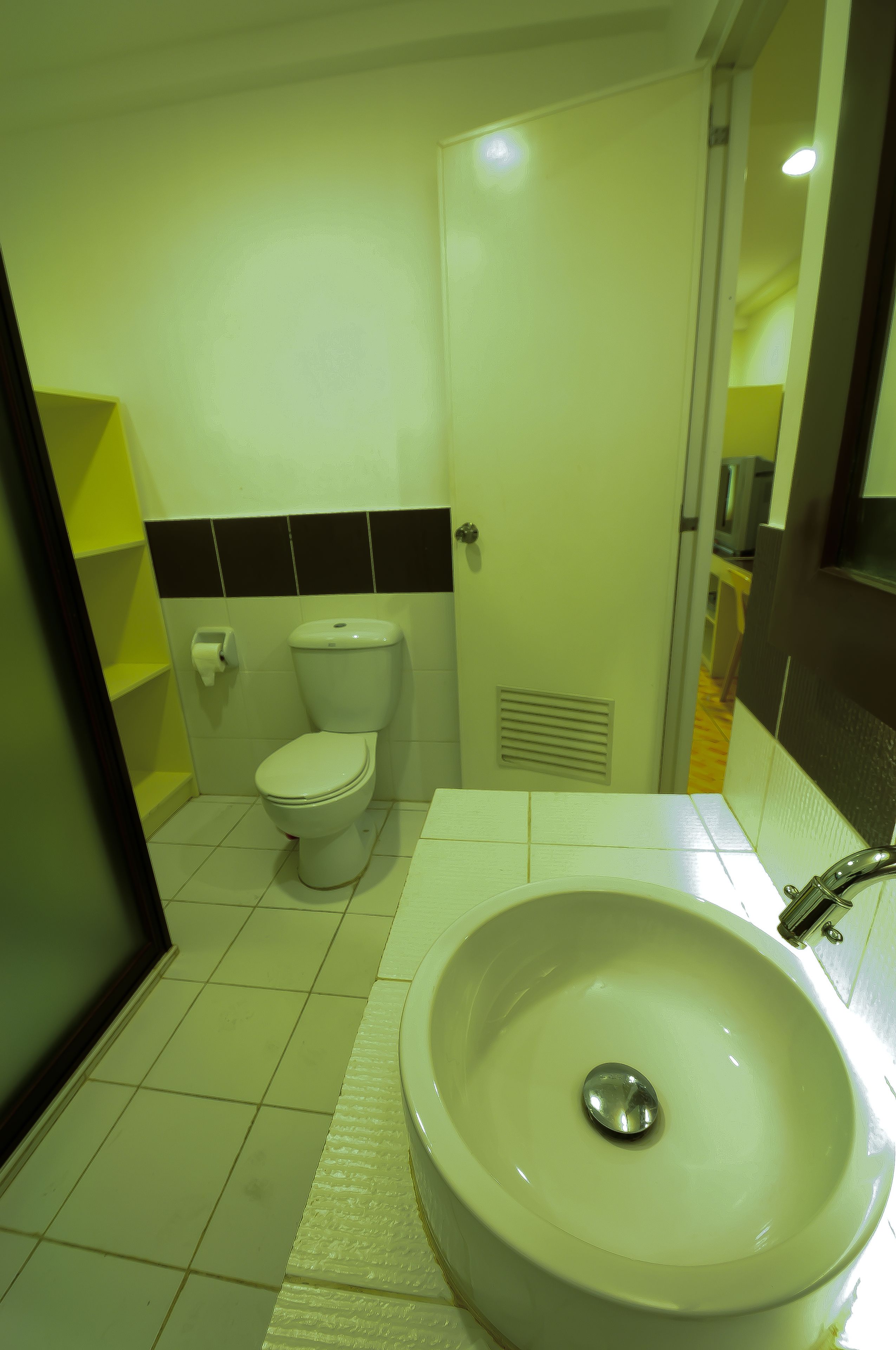 Un baño con inodoro, lavamanos y espejo.