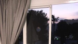 A balcony with a sliding glass door, a round table, and two chairs. - Apartamentos Bermudas (Benidorm)