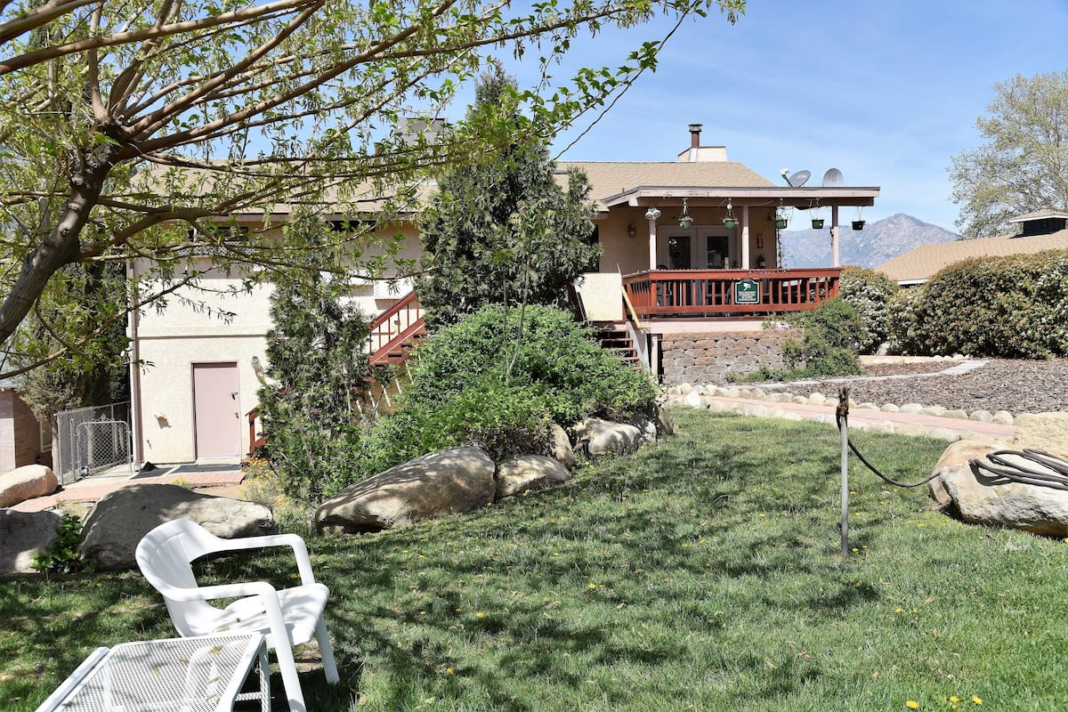 A house with a front porch, a covered patio, and a view of mountains.