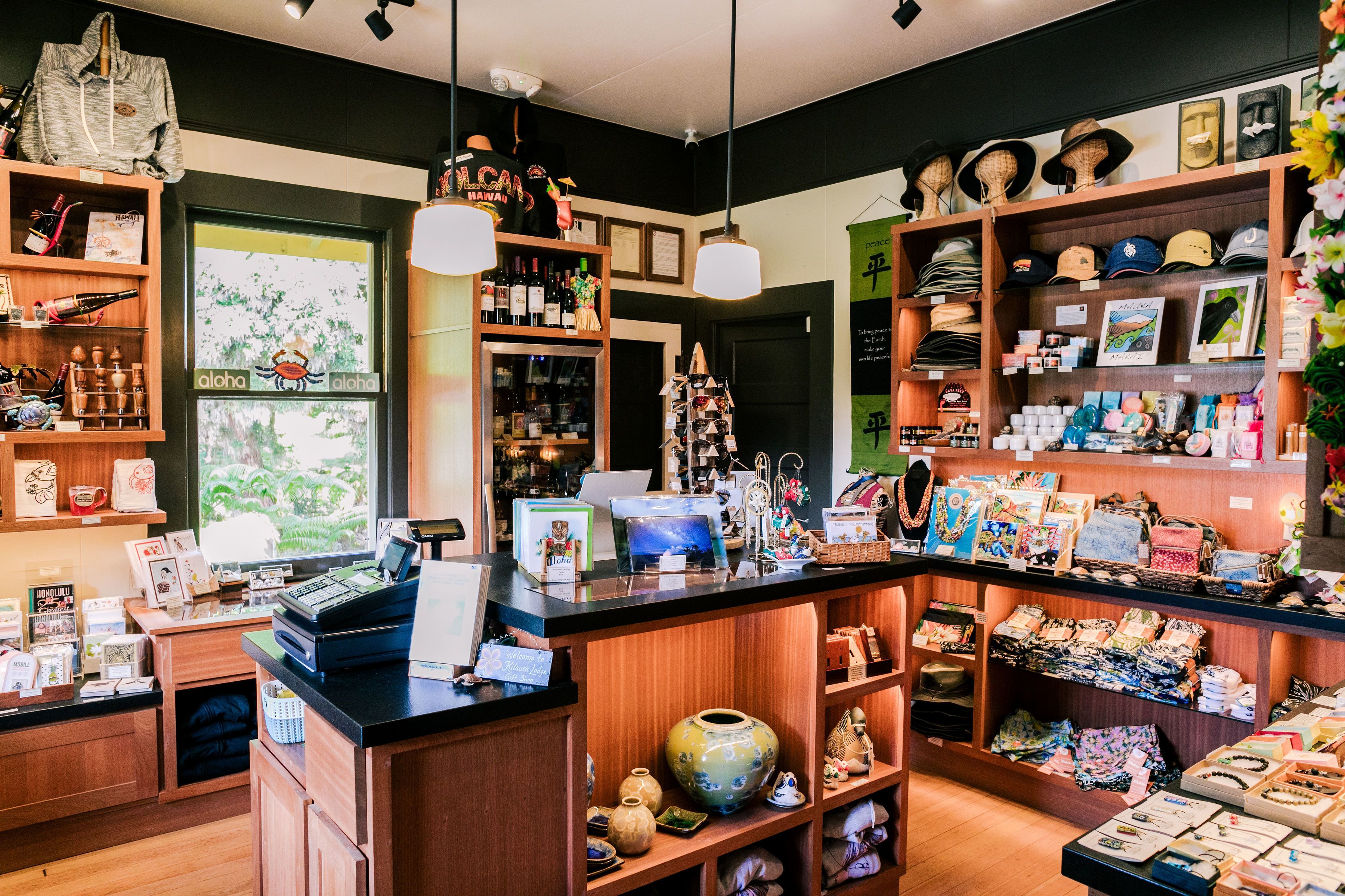 A shop with wooden shelves, a cash register, and various items for sale.