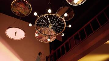 A chandelier with multiple circular mirrors and lights in a dimly lit room.
