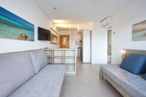 Apartment, 1 Bedroom, Balcony | Living area | Flat-screen TV - Playa Bella Beach Apartments (Sant Josep de sa Talaia)