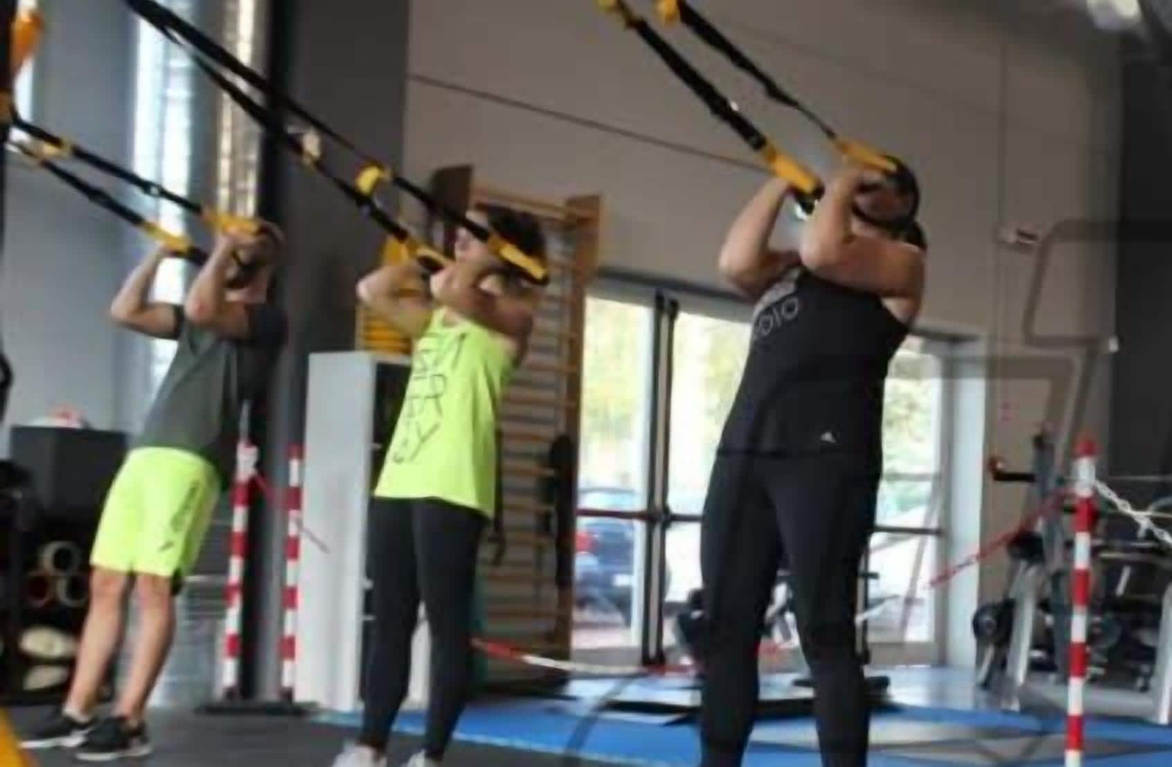 A gym with exercise equipment and mats.