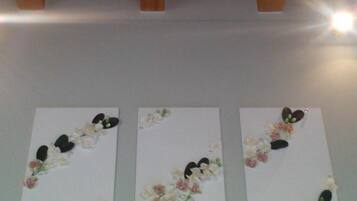Three white panels with floral and leaf decorations.