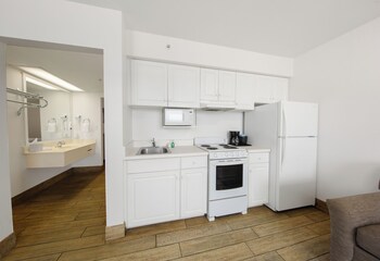 Deluxe Suite, 1 King Bed, Kitchen, Beachfront | Private kitchen | Full-size fridge, microwave, oven, stovetop at Holiday Terrace Beachfront Hotel, a By The Sea Resort