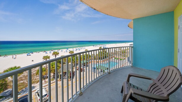 A balcony with a view of a beach and a pool. - Holiday Terrace Beachfront Hotel, a By The Sea Resort (Panama City Beach)