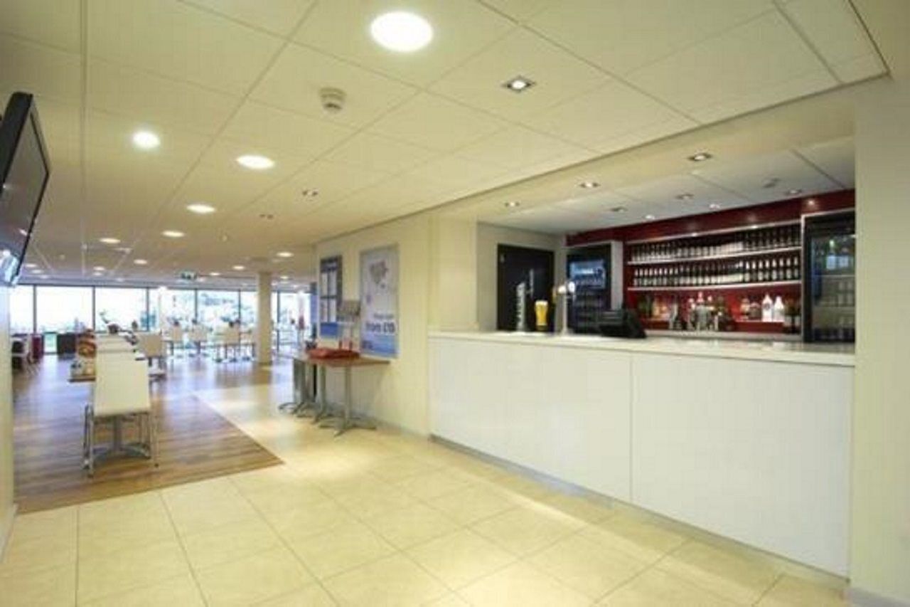 A spacious lobby with a reception desk, seating area, and a display of products.