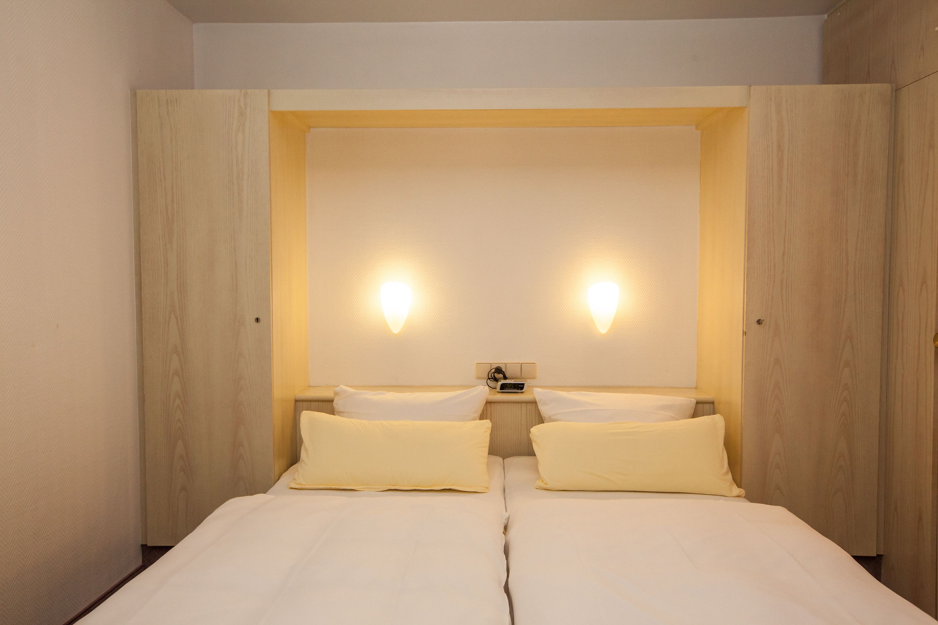 economy double room, courtyard area | hypo-allergenic bedding, in-room safe, desk, iron/ironing board