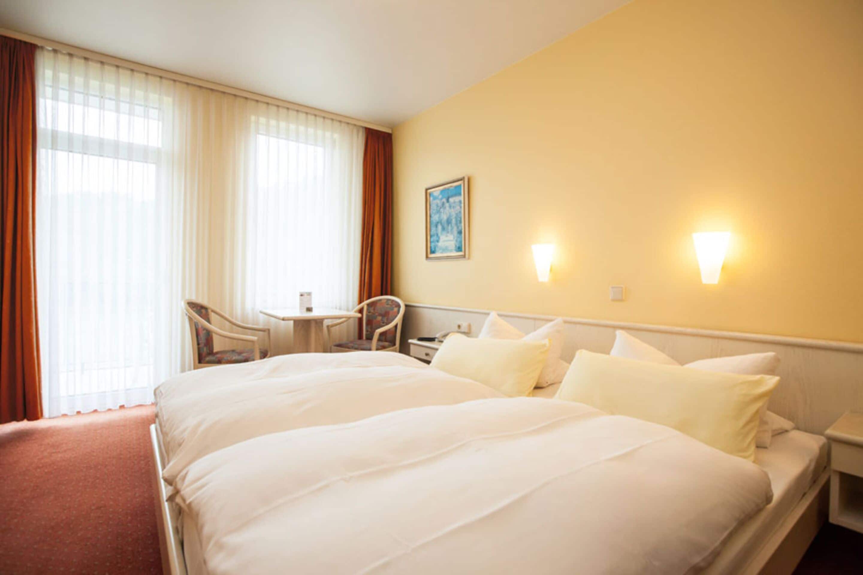 economy double room, courtyard area | hypo-allergenic bedding, in-room safe, desk, iron/ironing board