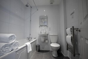 A modern bathroom with a bathtub, toilet, and sink. - Park Central Hotel (Bournemouth)