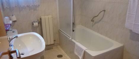 A bathroom with a bathtub, a sink, and a toilet.
